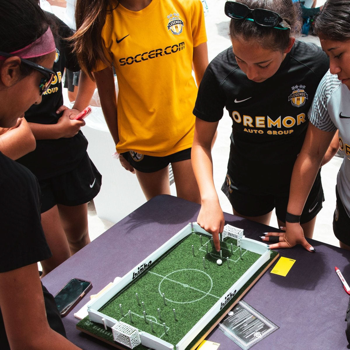 Teens playing Binho Soccer Tabletop Game