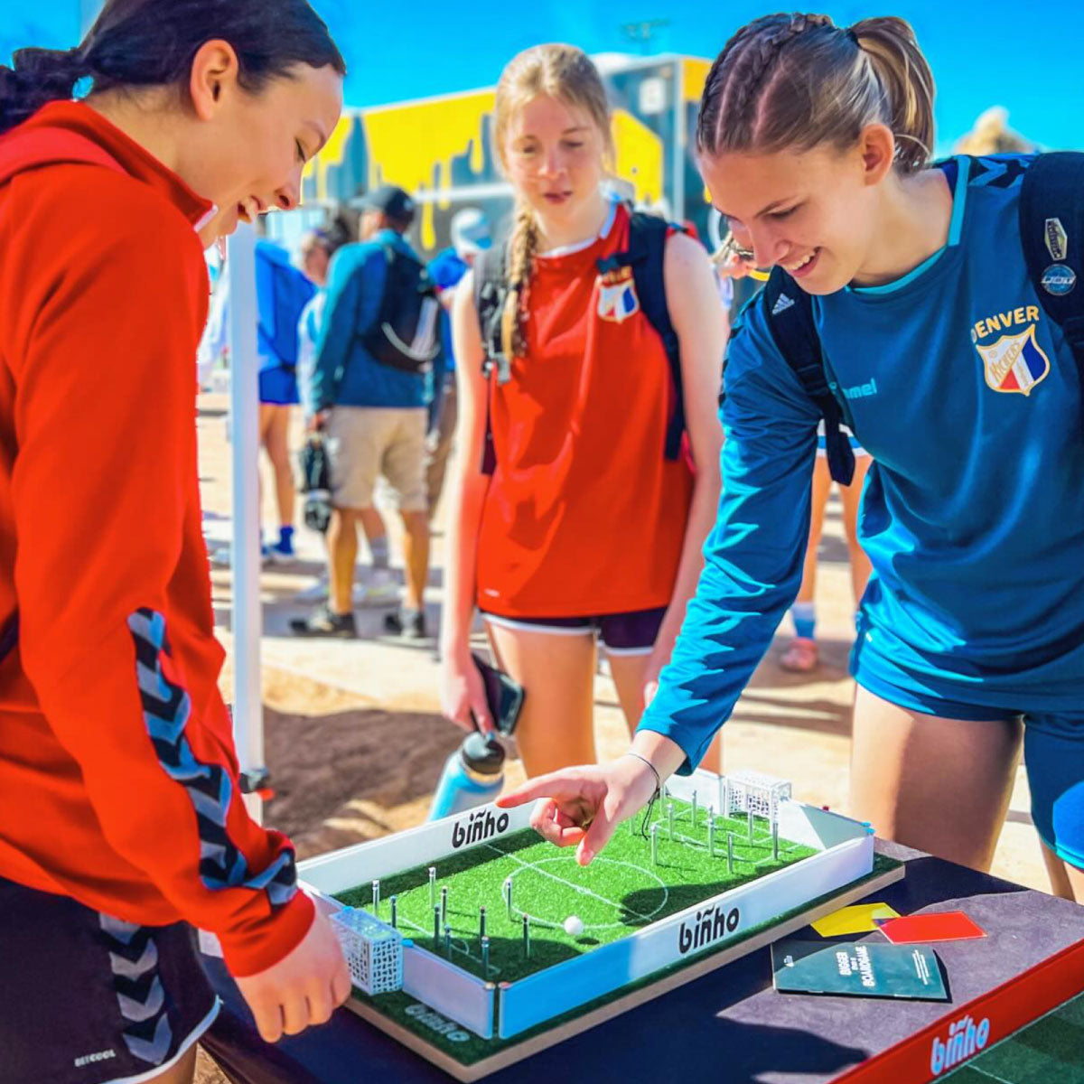 Teens playing Binho Soccer Tabletop Game