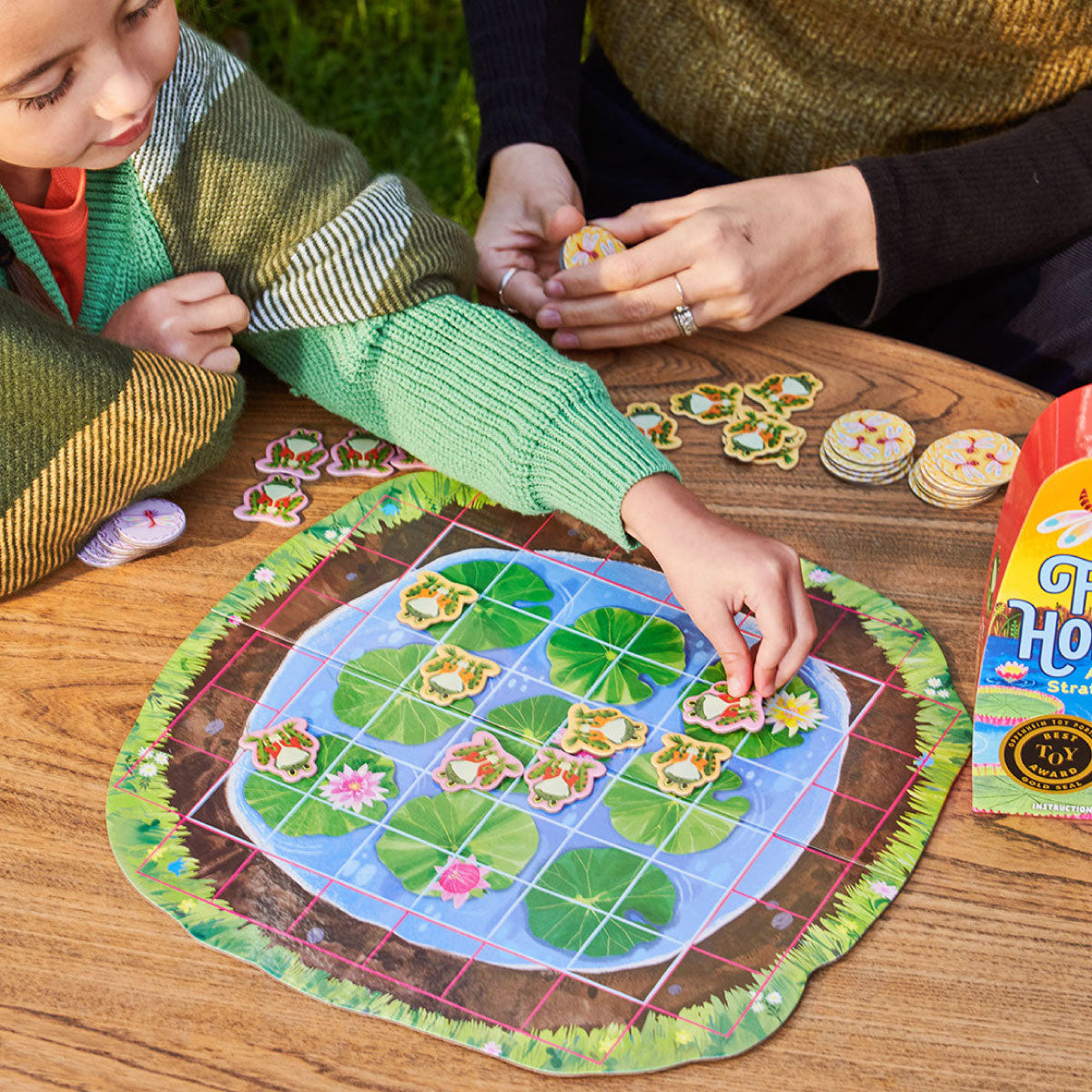 Child playing eeBoo's Frog Hopkins Board Game