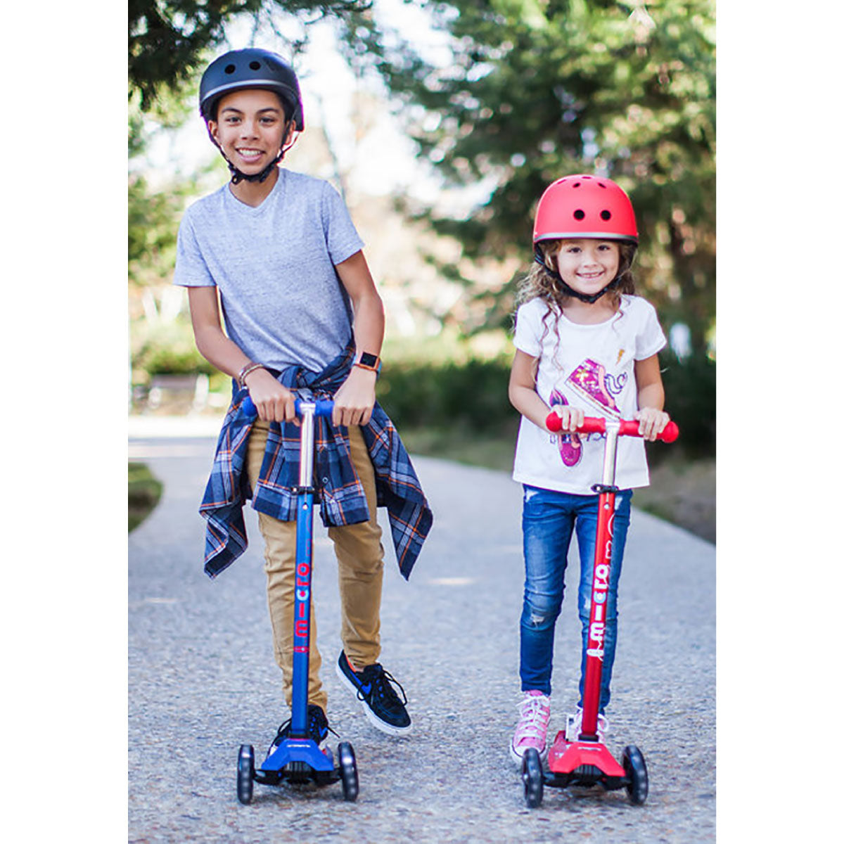 Kids riding Micro Kickboard Maxi Deluxe Scooters with LED Wheels. These are our favorite scooters for kids five to ten years old.