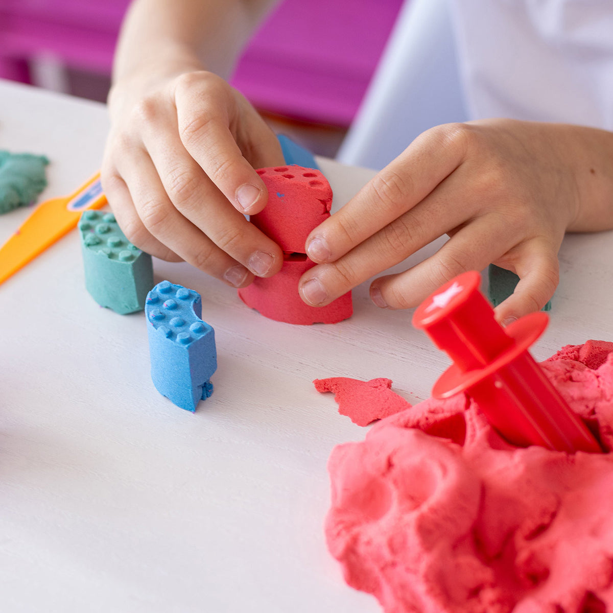 Child building with molded bricks - Mad Mattr Quantum Tool Box 
