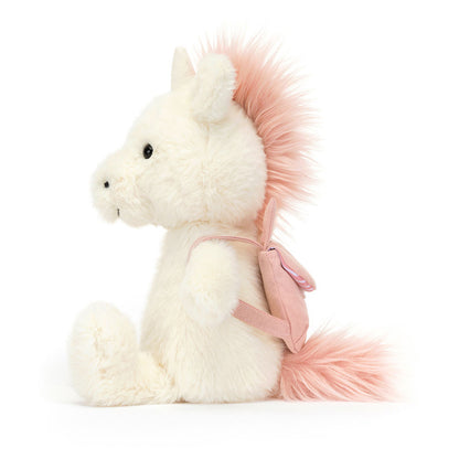 A plush unicorn wearing a pink unicorn backback, by Jellycat.