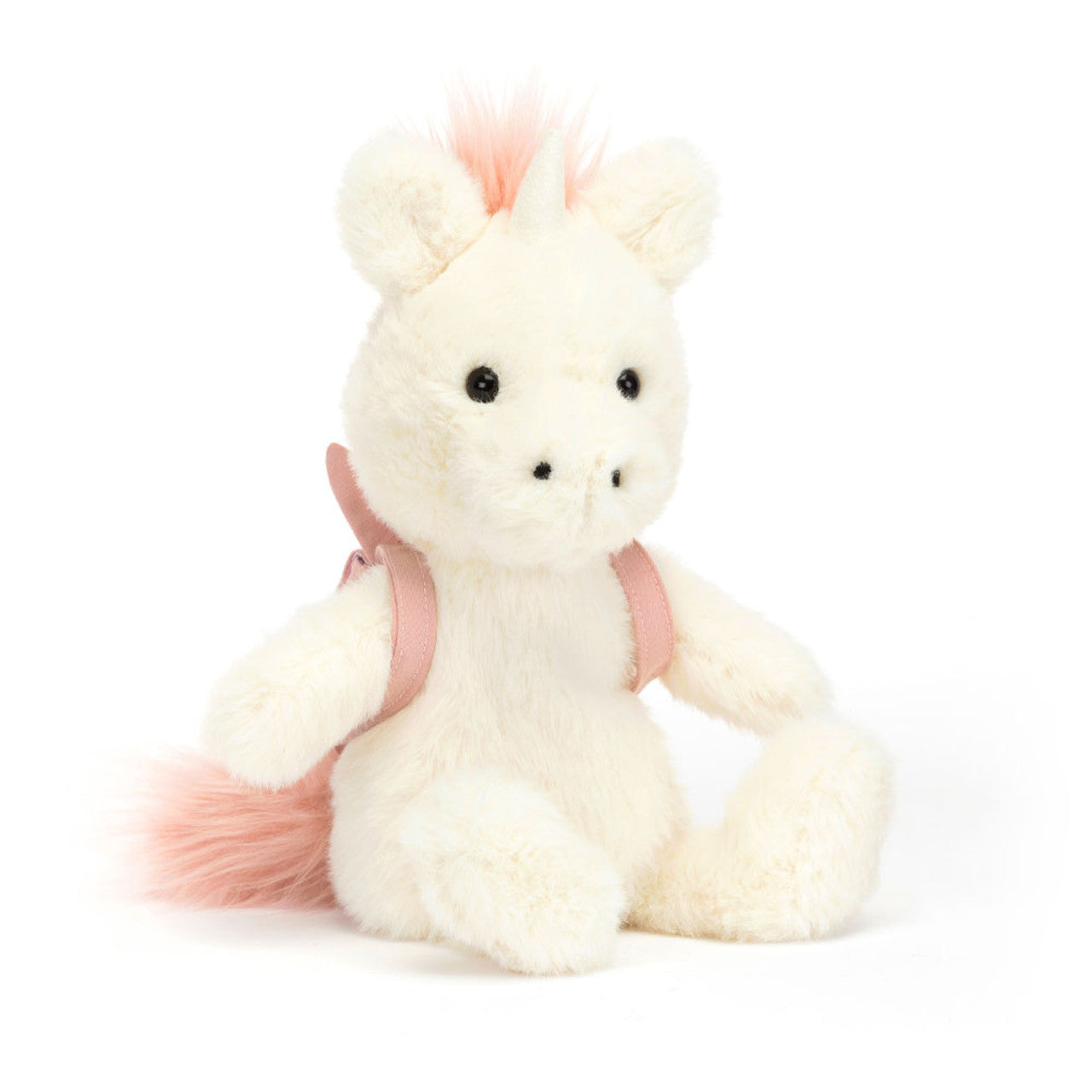 A plush unicorn wearing a pink unicorn backback, by Jellycat.