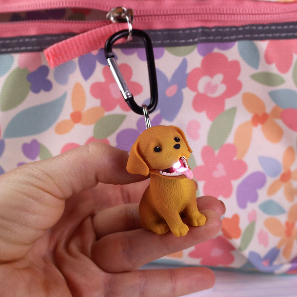 Golden Retriever Big Discoveries Wildlights LED Carabiner Animal & Dinosaur Lights in a hand and shining the flashlight