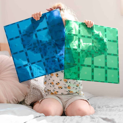 Child holding Connetix Blue & Green Base Plates