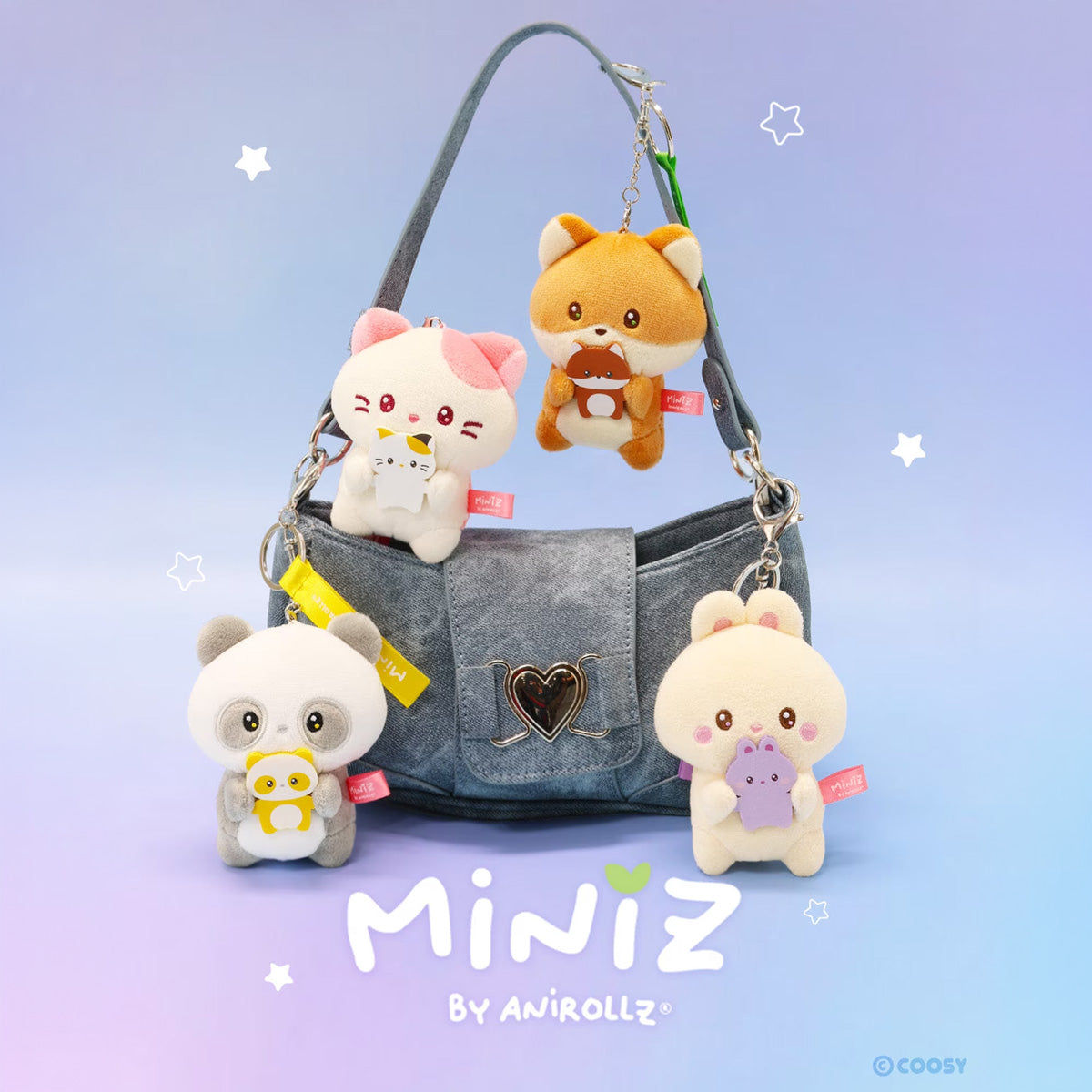 Anirollz Miniz Mini-Me Plush Bag Clips on a blue denim-style shoulder bag displayed on a pastel gradient background,Shows four cute plush animal keychains: a white cat with pink ears, an orange fox, a panda, and a cream rabbit. The text 'MINIZ BY ANIROLLZ' and a small '©COOSY' mark are visible.