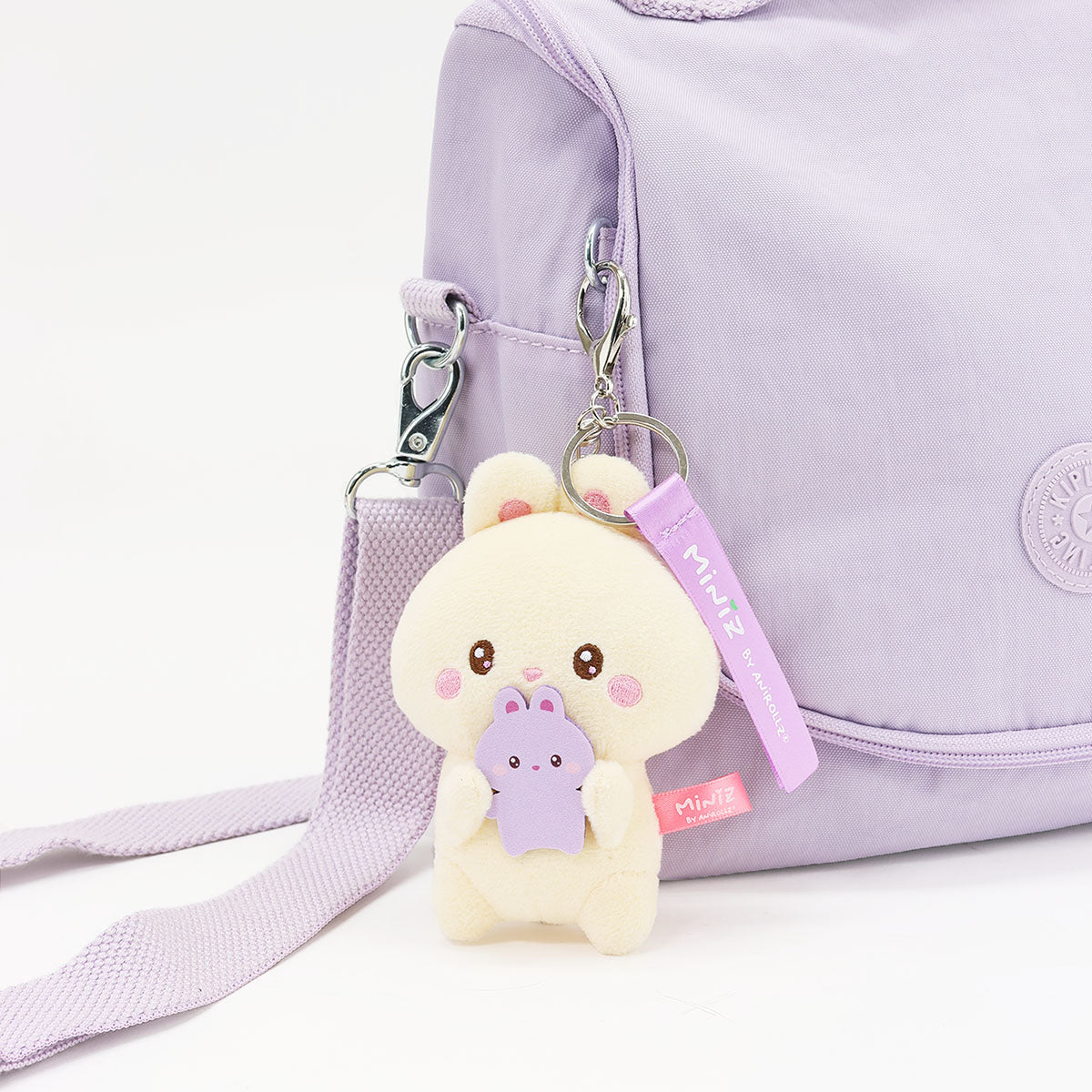 Coosy Anirollz Miniz Mini-Me Bunniroll clipped to a bag.