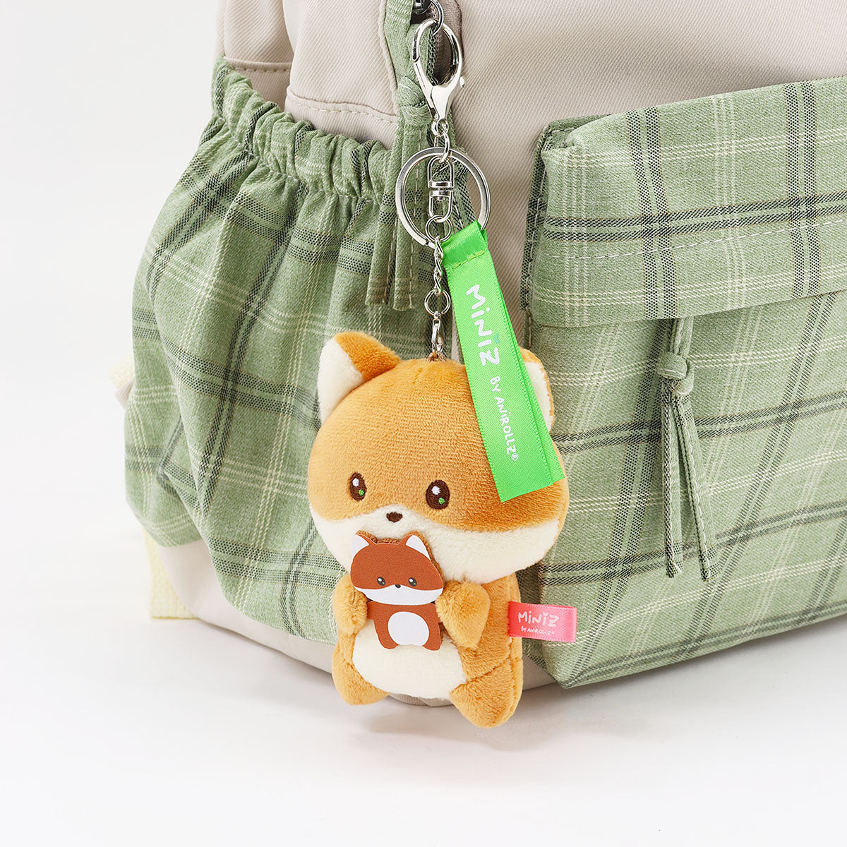 Coosy Anirollz Miniz Mini-Me Foxiroll clipped to a bag.