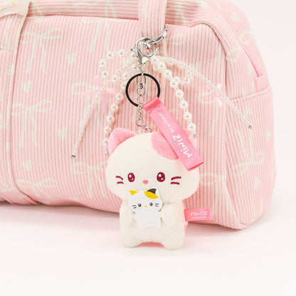 Coosy Anirollz Miniz Mini-Me Kittiroll clipped to a bag.