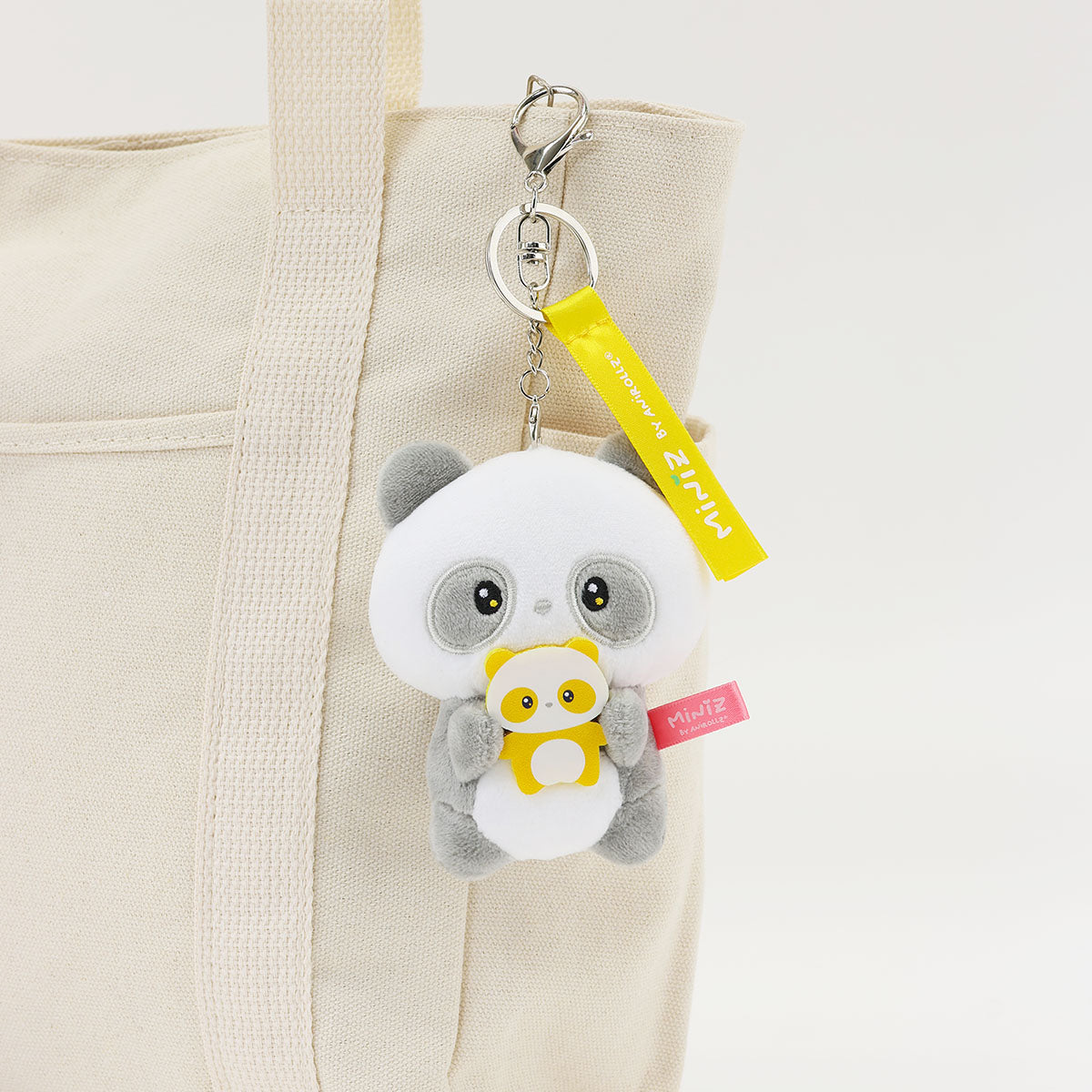 Coosy Anirollz Miniz Mini-Me Pandaroll clipped to a bag.