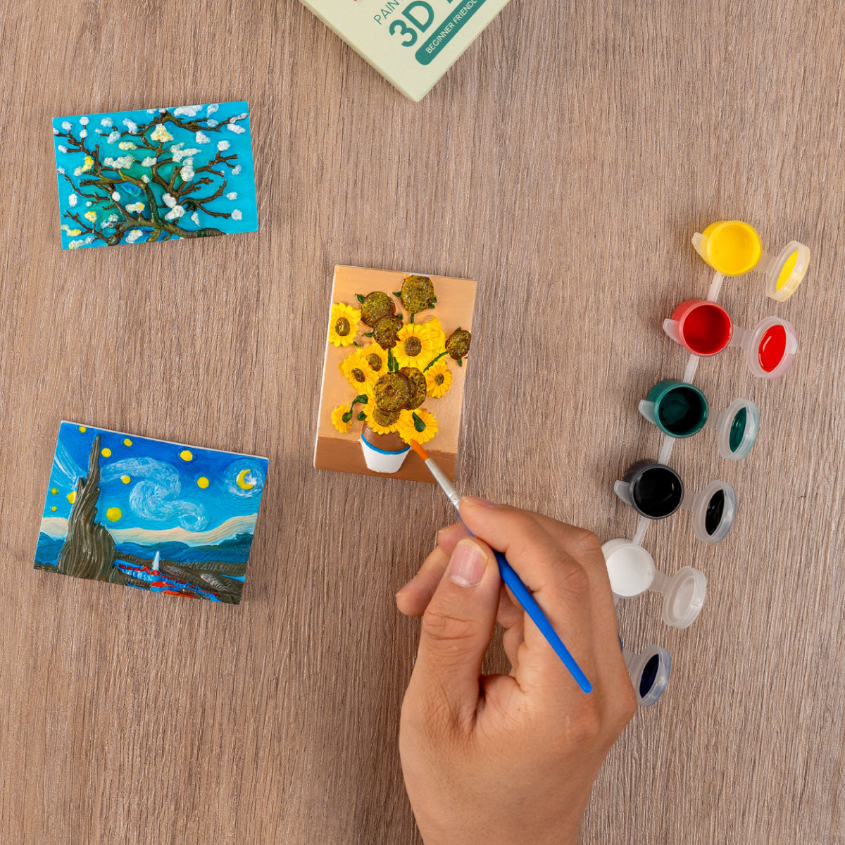 Hand painting one of the Craft Hero Muddies Van Gogh’s Masterpieces 3D Magnets Painting Kit 