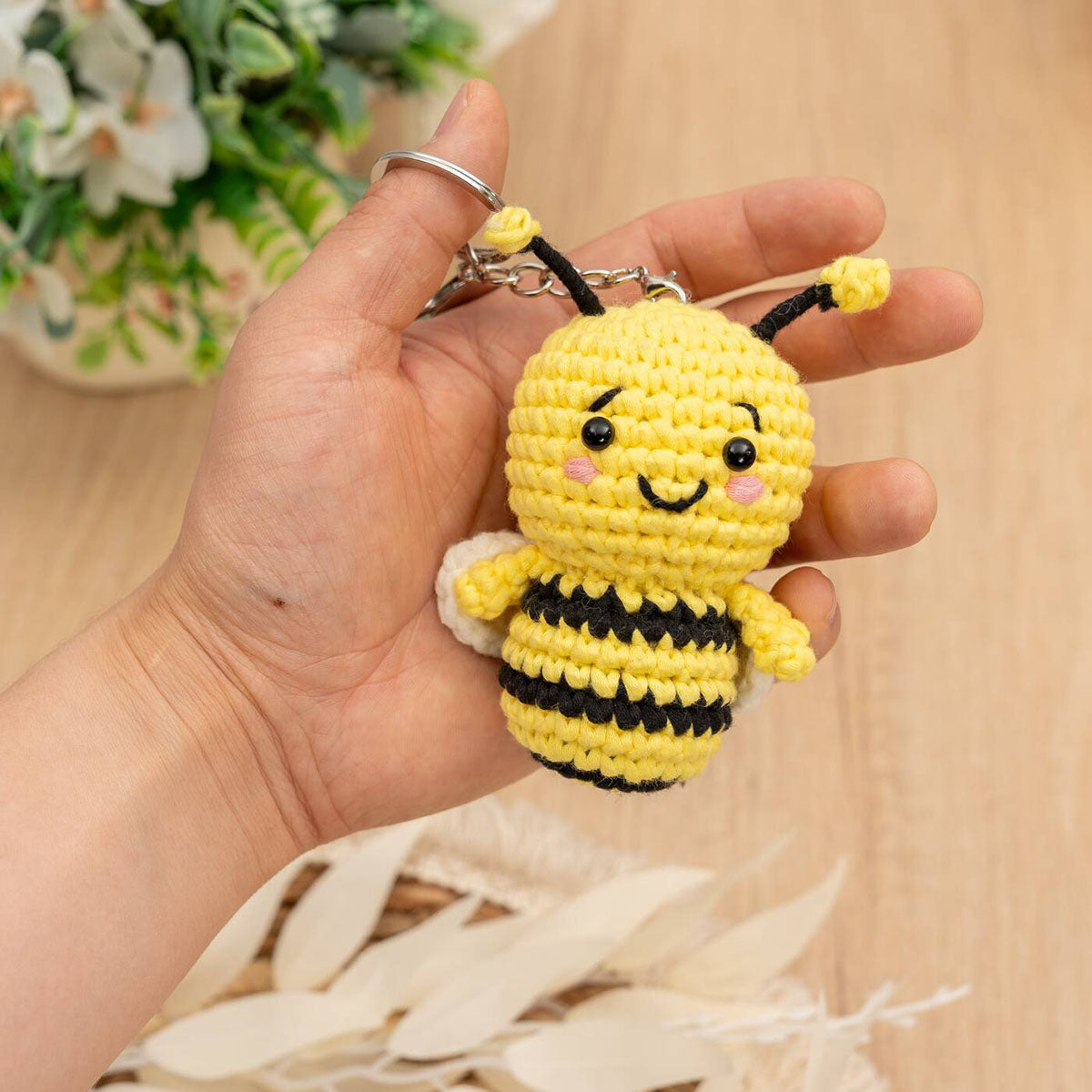 Craft Hero Threadies Beatrice Bee Crochet Kit completed project in a person's hand