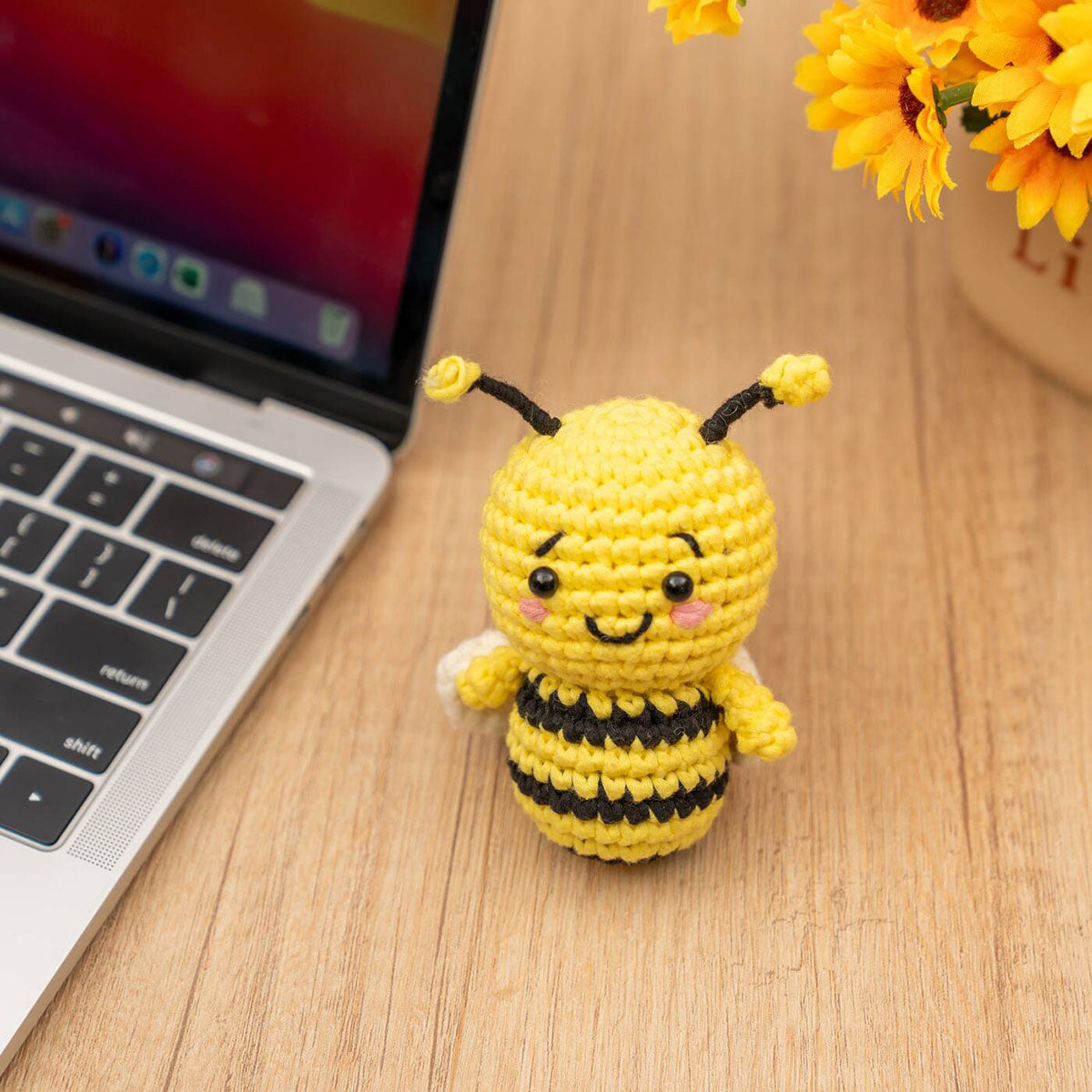 Craft Hero Threadies Beatrice Bee Crochet Kit completed project sitting on a desk.