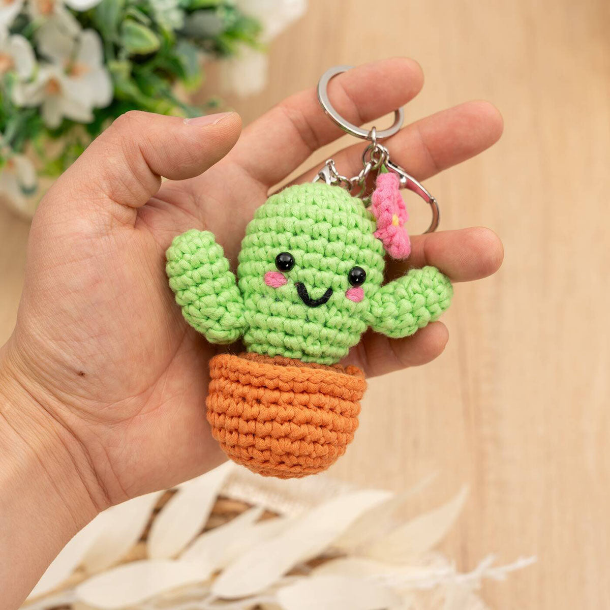 Craft Hero Threadies Carla Cactus Crochet Kit completed project in a person's hand.