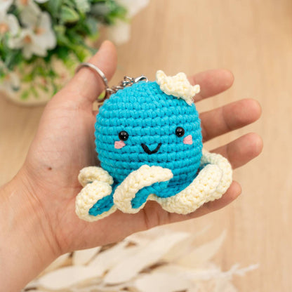 Completed Craft Hero Threadies Ollie Octopus Crochet Kit in a person's hand