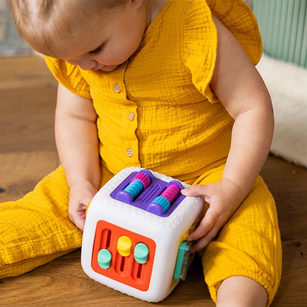 Child playing with the Fat Brain Toy Co PlayTab Activity Cube