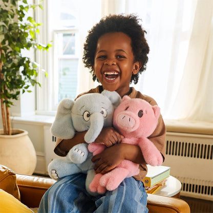Child hugging the GUND Gerald the Elephant and Piggie Plush stuffed animals from the Mo Willems Collection