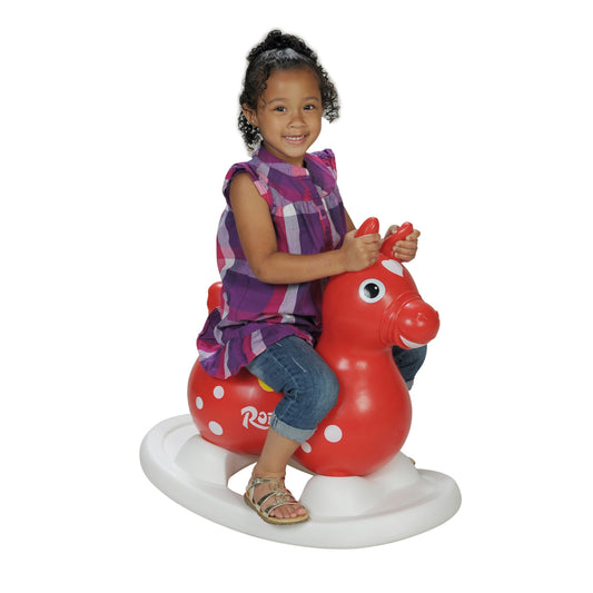 Child riding a Rody horse with the Gymnic Rody Rocking Base attached.