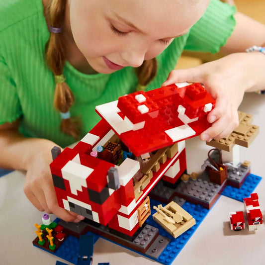 Child playing with LEGO Minecraft The Mooshroom House set