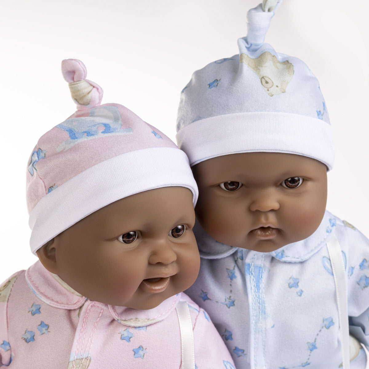 Lots to Cuddle Babies 13" twins soft body baby dolls with brown-black skin. One wearing pink pajamas, the other in blue.