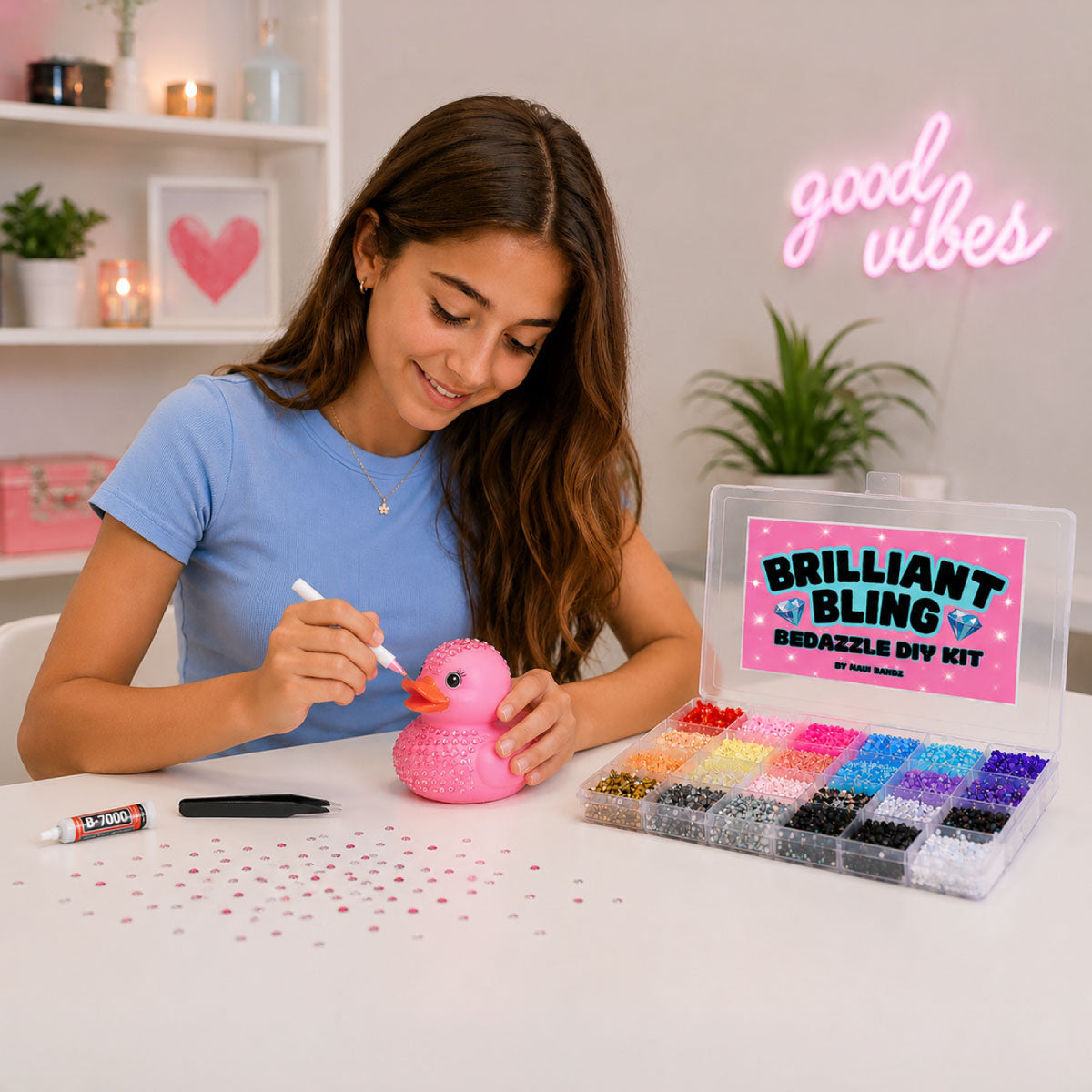 A teen girl sits at a white table, customizing a pink rubber duck with gemstones from the Brilliant Bling Bedazzle Kit. 