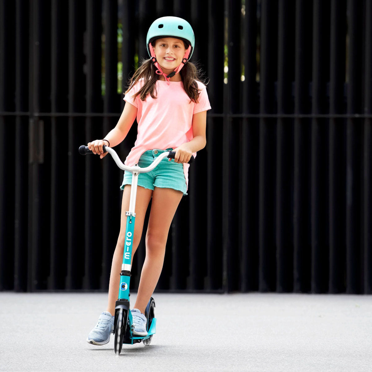 Micro Kickboard Cruiser LED Scooter with teen girl riding