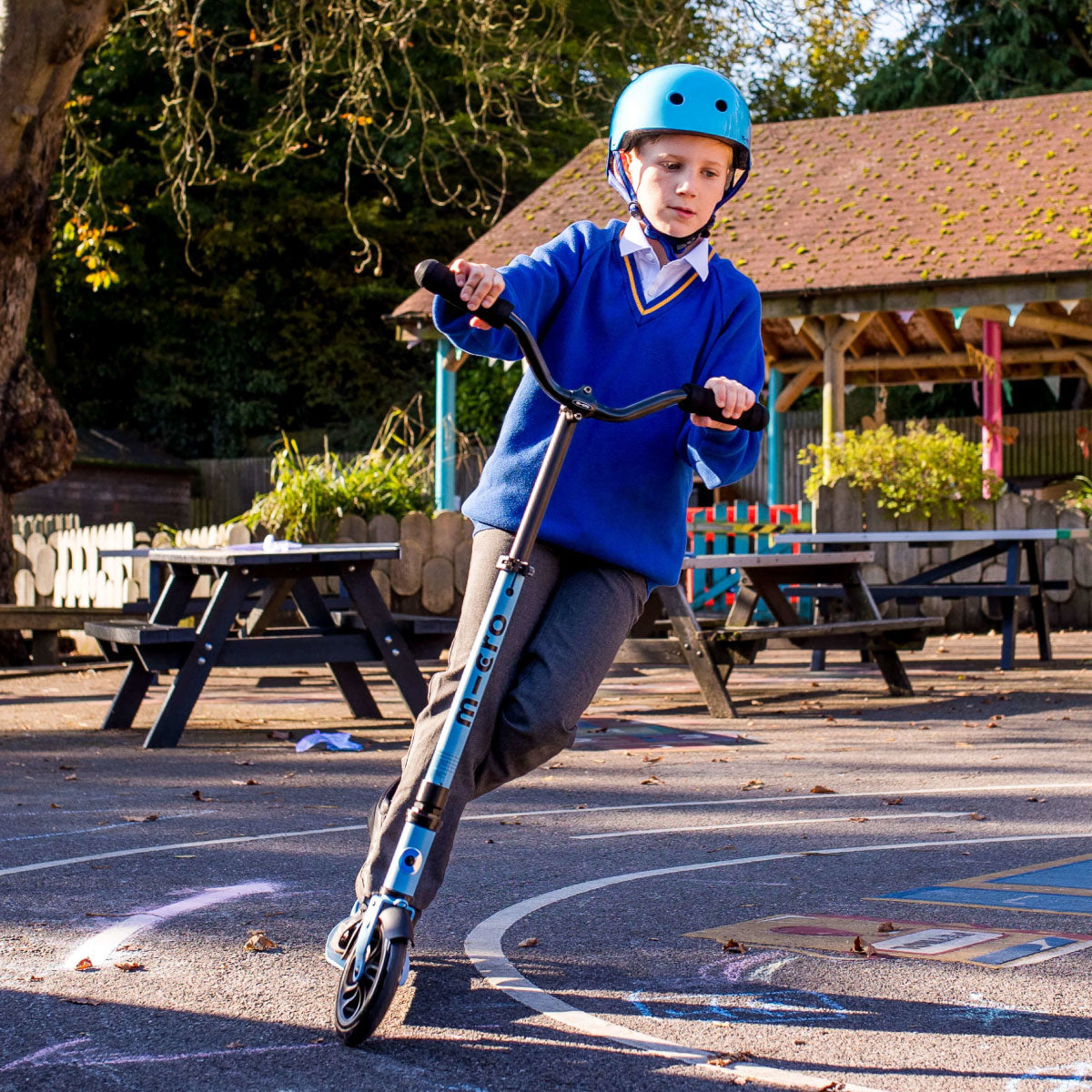 Micro Kickboard Speed Deluxe Scooter in Alaskan Blue with teen rider going fast