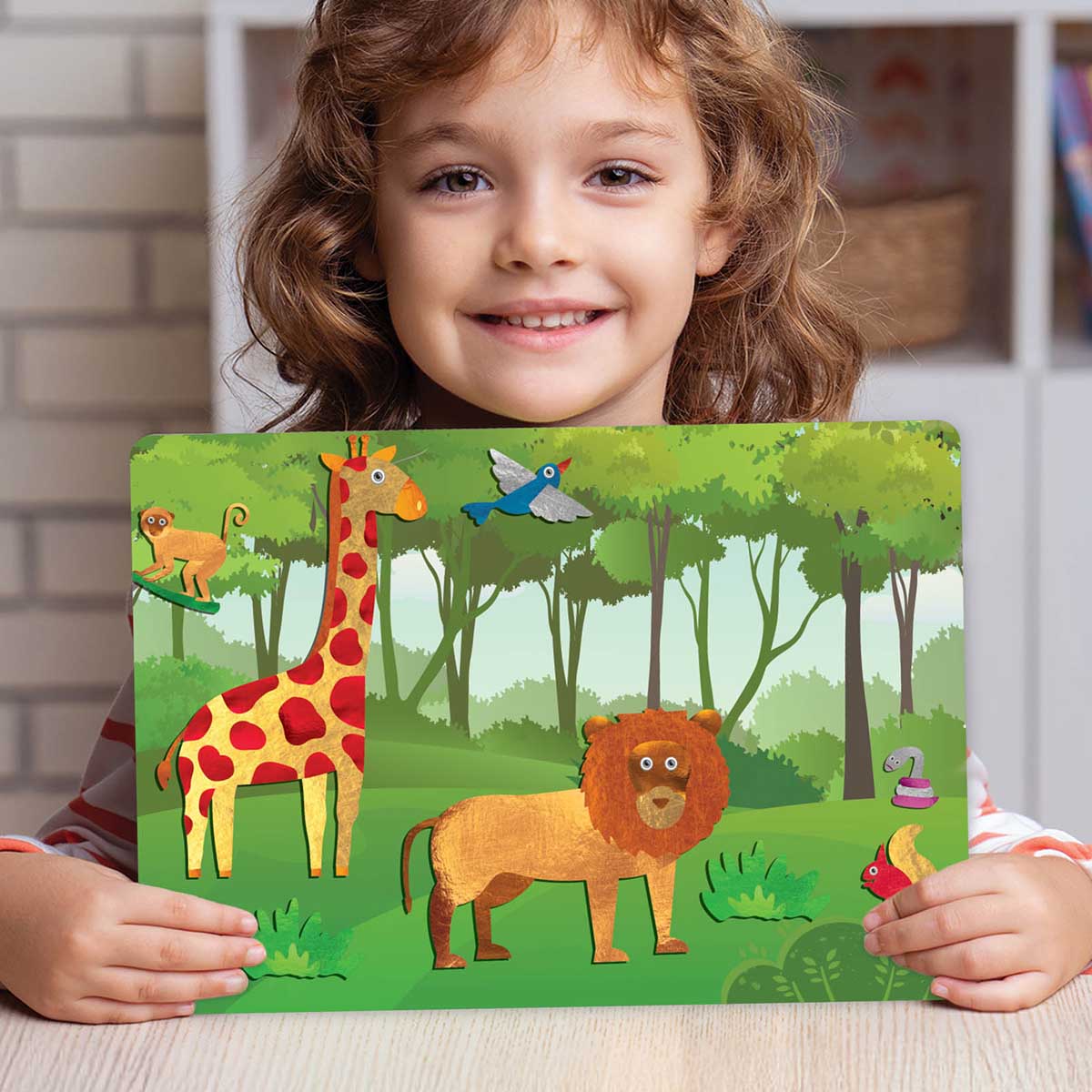 Child smiling and holding finished art. Skillmatics - Peel & Press Foil Fun Art Kit - World of Animals