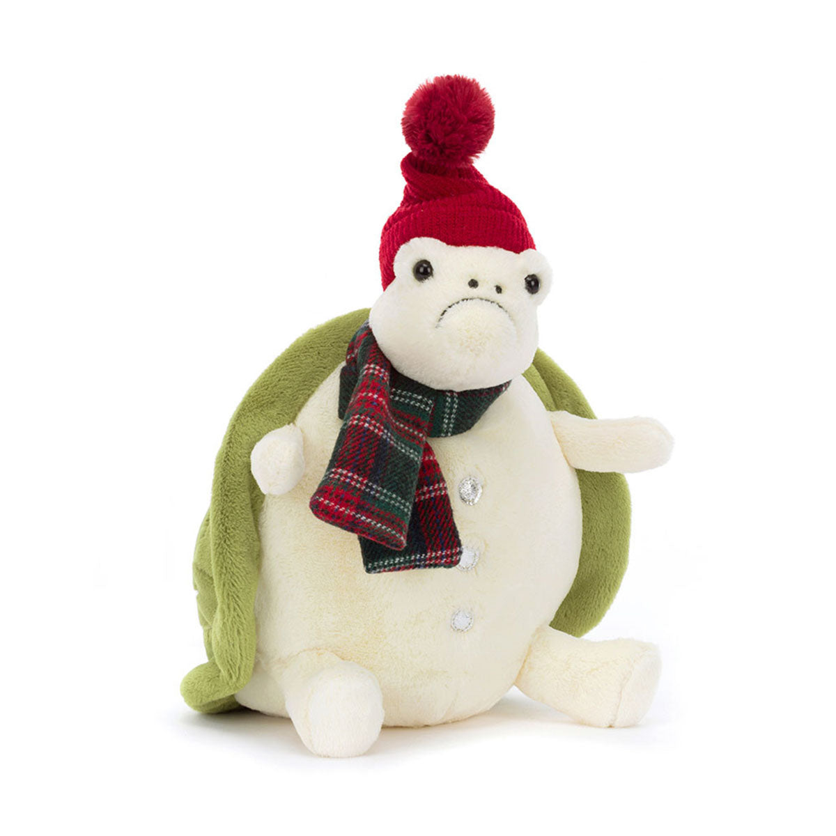 Snowman Timmy Turtle with a pouty expression wears a red knitted pom beanie, silver stitch buttons, and a plaid tartan scarf, in addition to his cream-colored body and green shell. By Jellycat.
