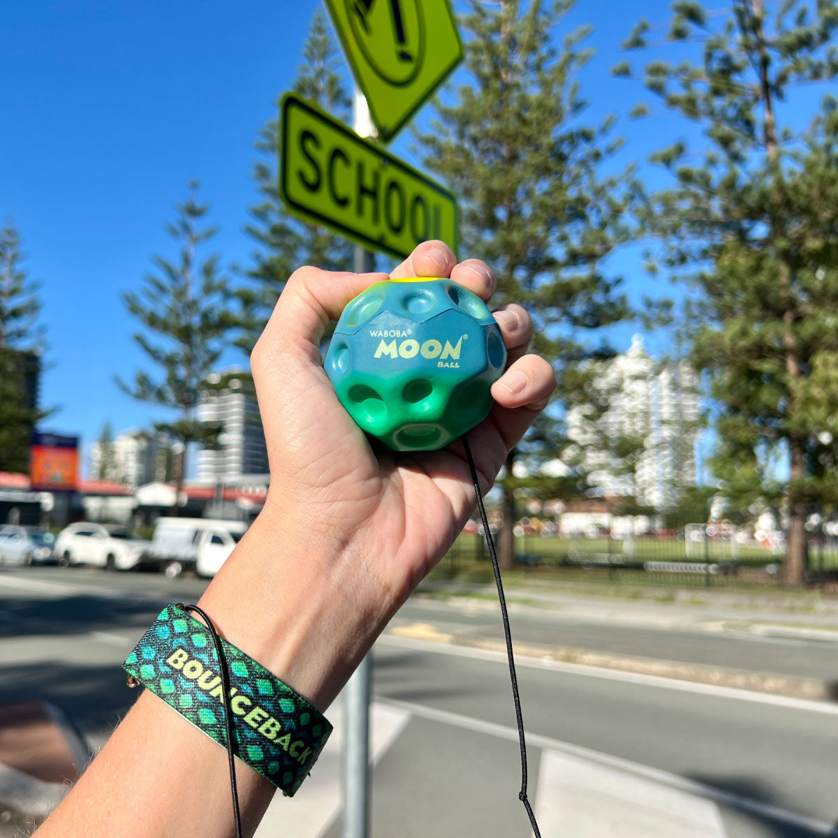Waboba Gradients BounceBack Moon Ball 2.5” - Green/blue/yellow in hand