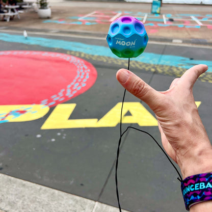 Waboba Gradients BounceBack Moon Ball 2.5” - Purple/blue/green in hand