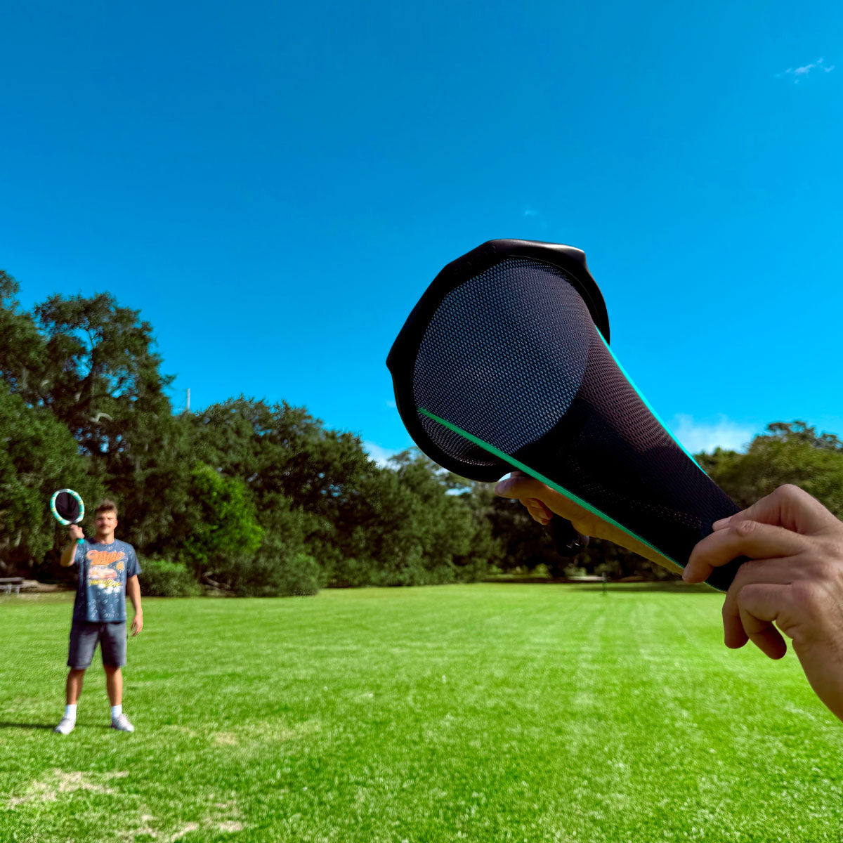 Waboba SlingAir Slingshot Catch Game - Pull back the ball in the racket's net to launch.